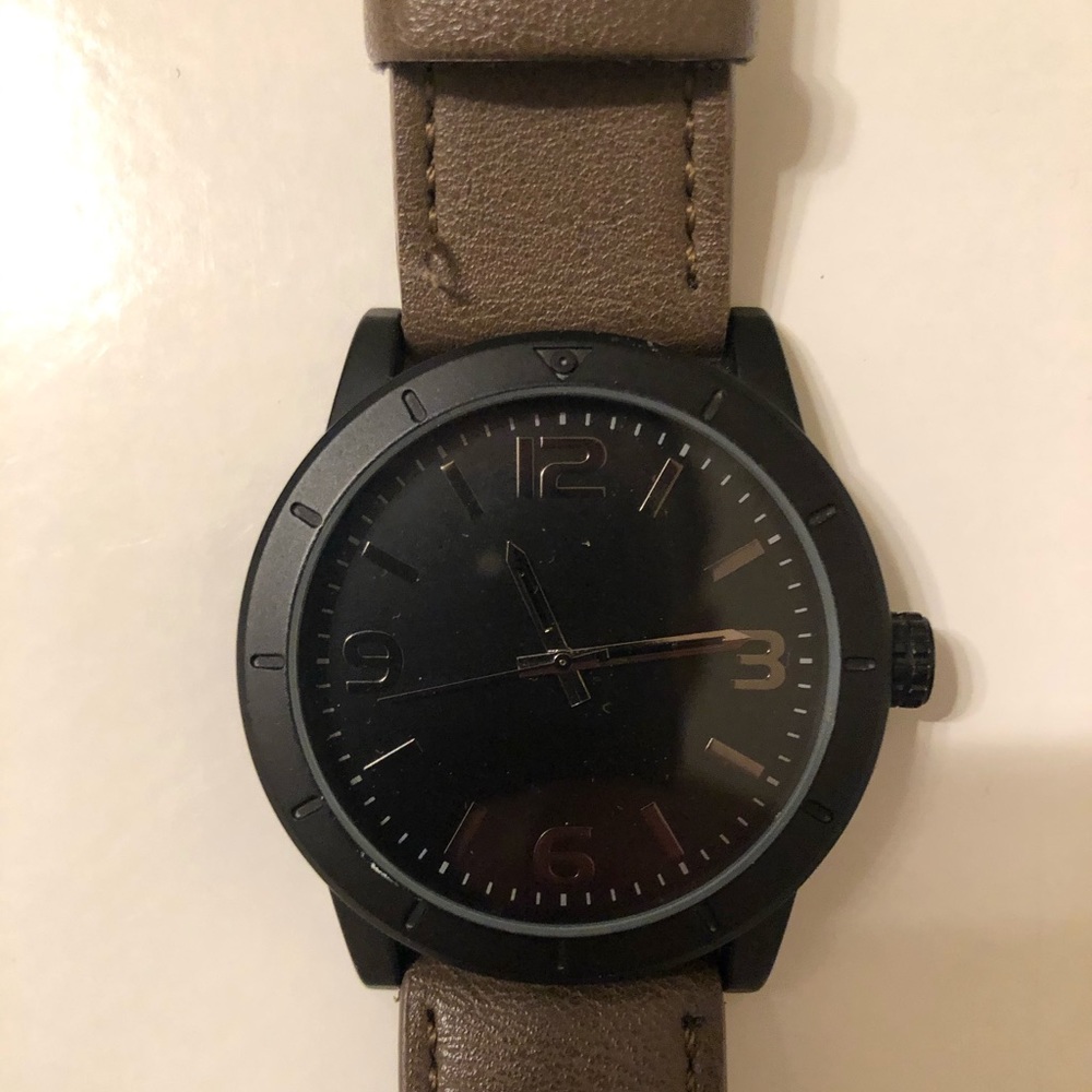 Black watch, light brown wristband